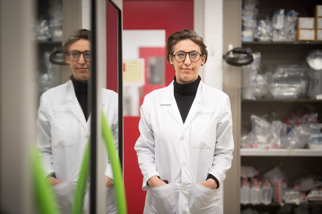 Dr Samira Mubareka wearing a lab coat in a lab.